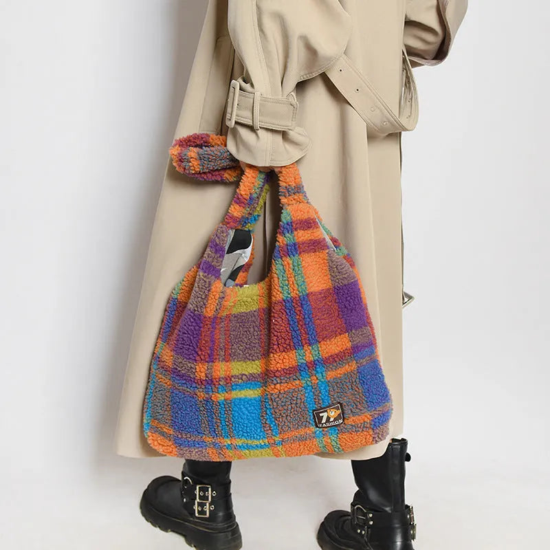 Women's plaid pattern crossbody tote bag showing soft plush material and horizontal square shape with crossbody strap.