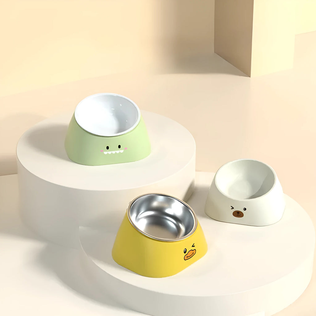 Green tilted stainless steel cat bowl at a 15-degree angle on a table.