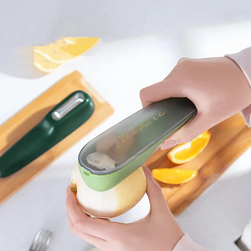 Green fruit and vegetable peeler with a storage tube and stainless steel blade.