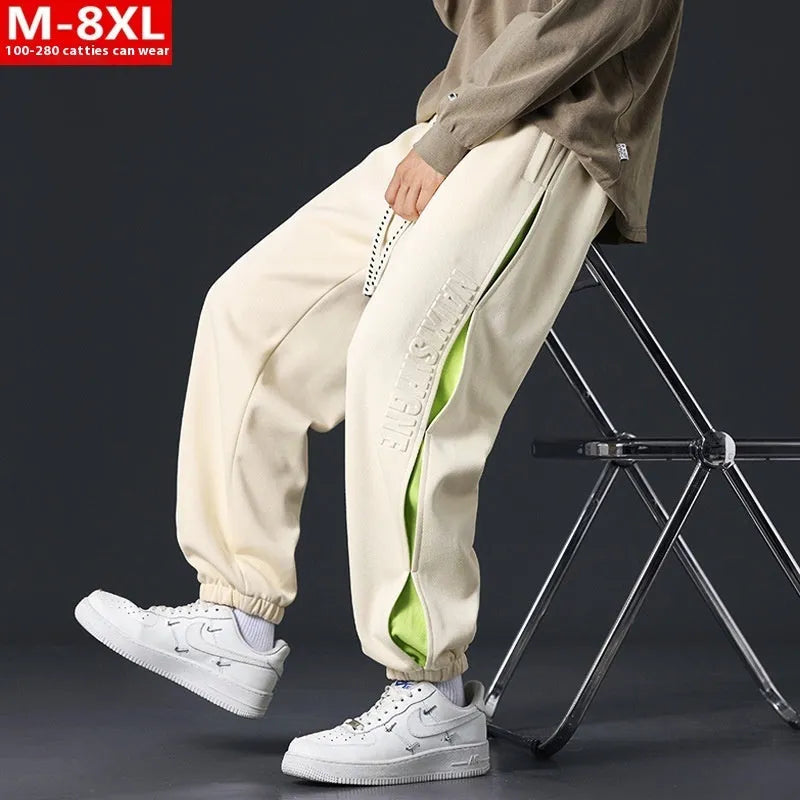 Men's loose fit cotton trousers with banded ankles and stitching details in grey green colour