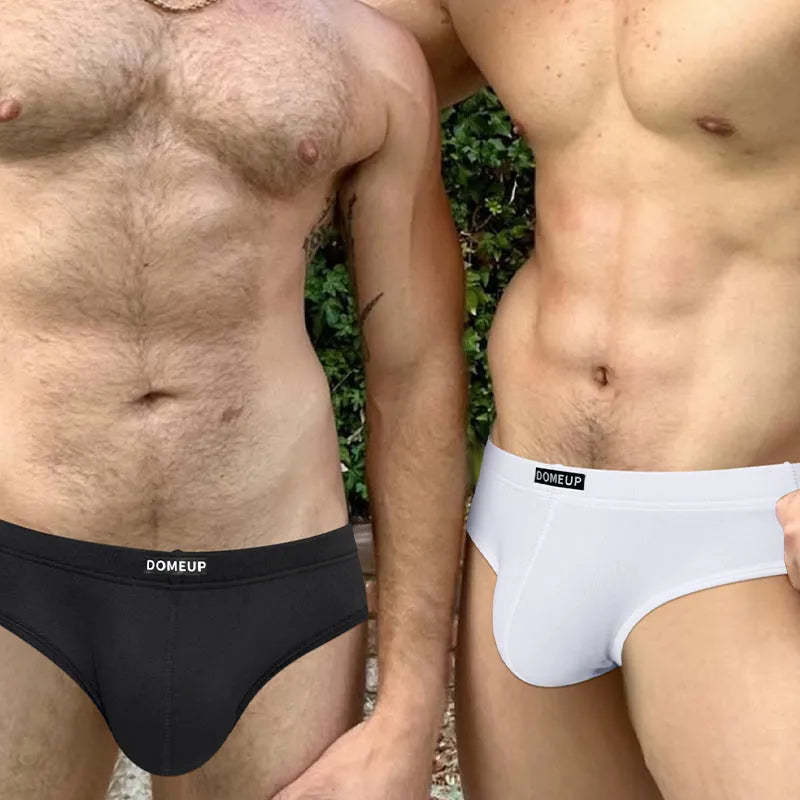 Men's solid colour low-waist briefs in black, shown flat, highlighting seamless construction.
