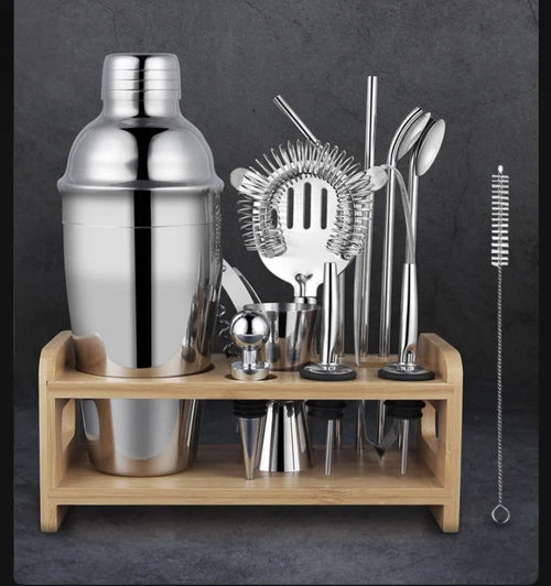23-piece European style stainless steel cocktail set with shaker, strainer, and bar tools on a table.