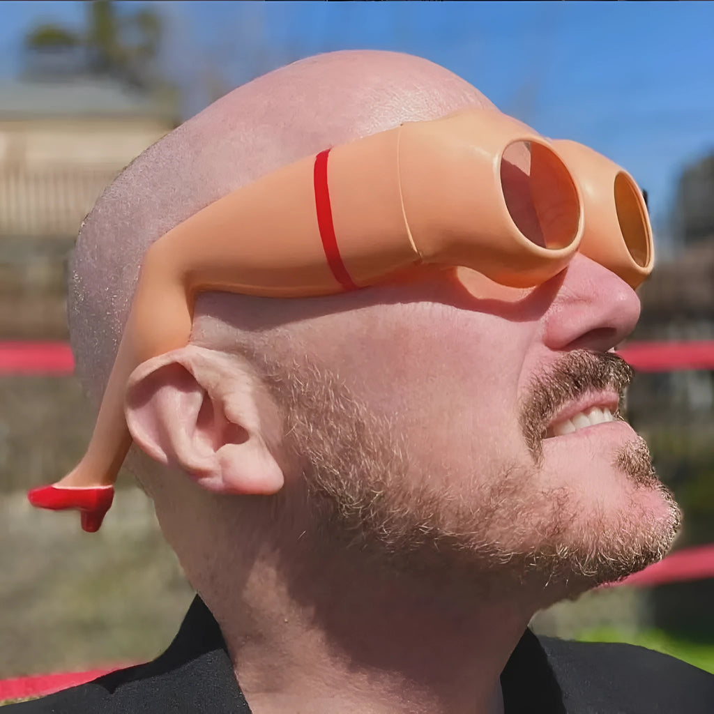 Orange plastic sunglasses with a personality leg and hip design.