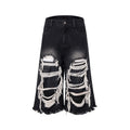 Black wide-leg cropped jeans with ripped patch detail on the legs, showing a mid-high waist and loose fit.