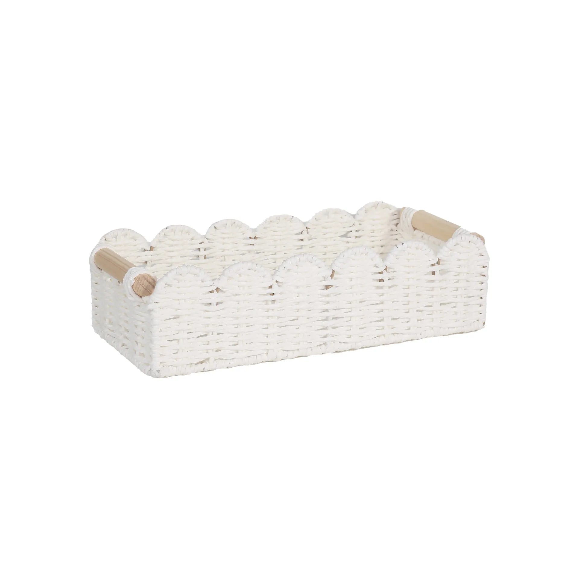 Woven paper storage basket in khaki colour on a desktop, holding remote controls and stationery.