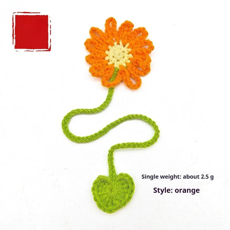 Hand-crocheted daisy flexible wire bookmark in yellow, pink, light purple, and orange colours.