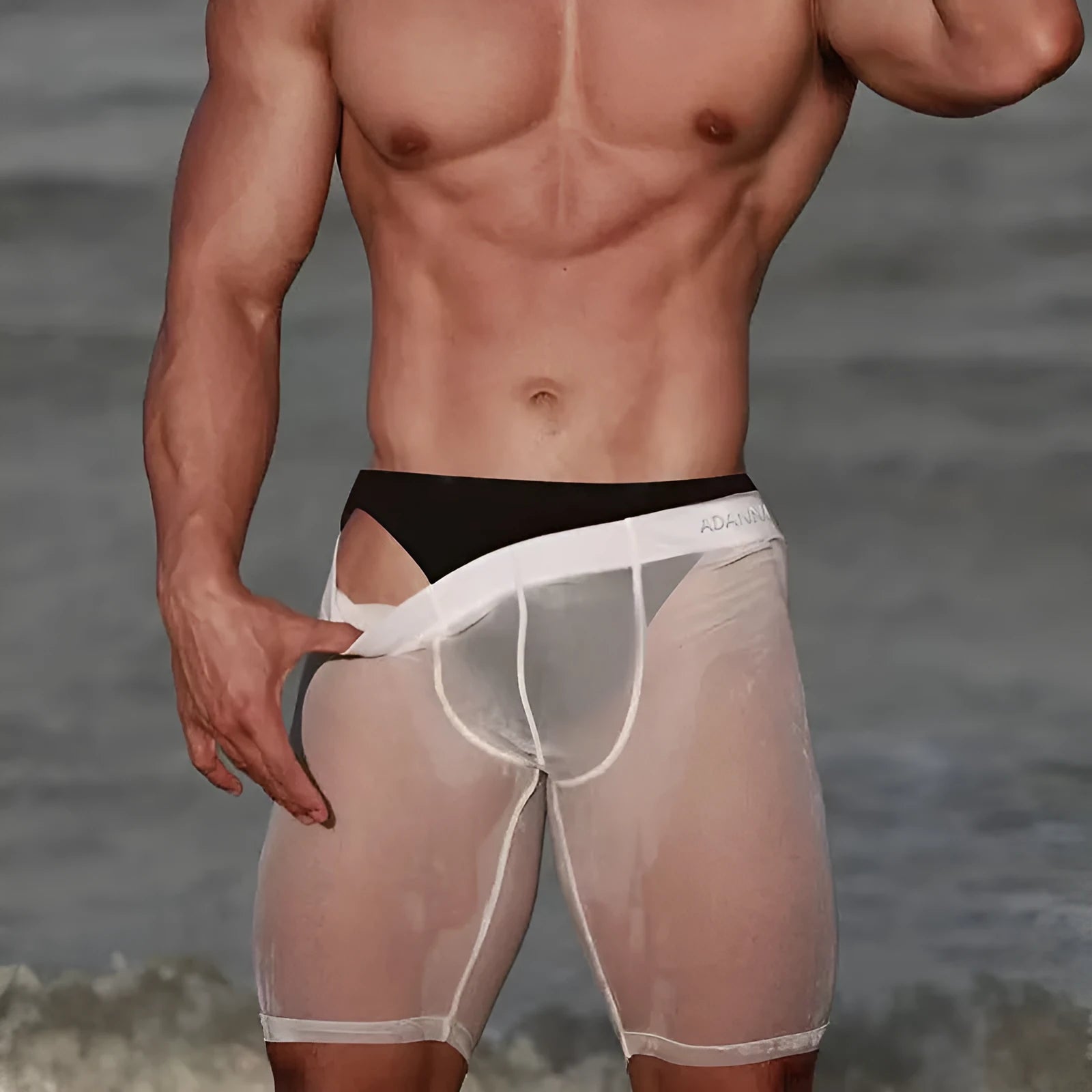 Man wearing black seamless knitted nylon mesh shorts with a hip lifting design.