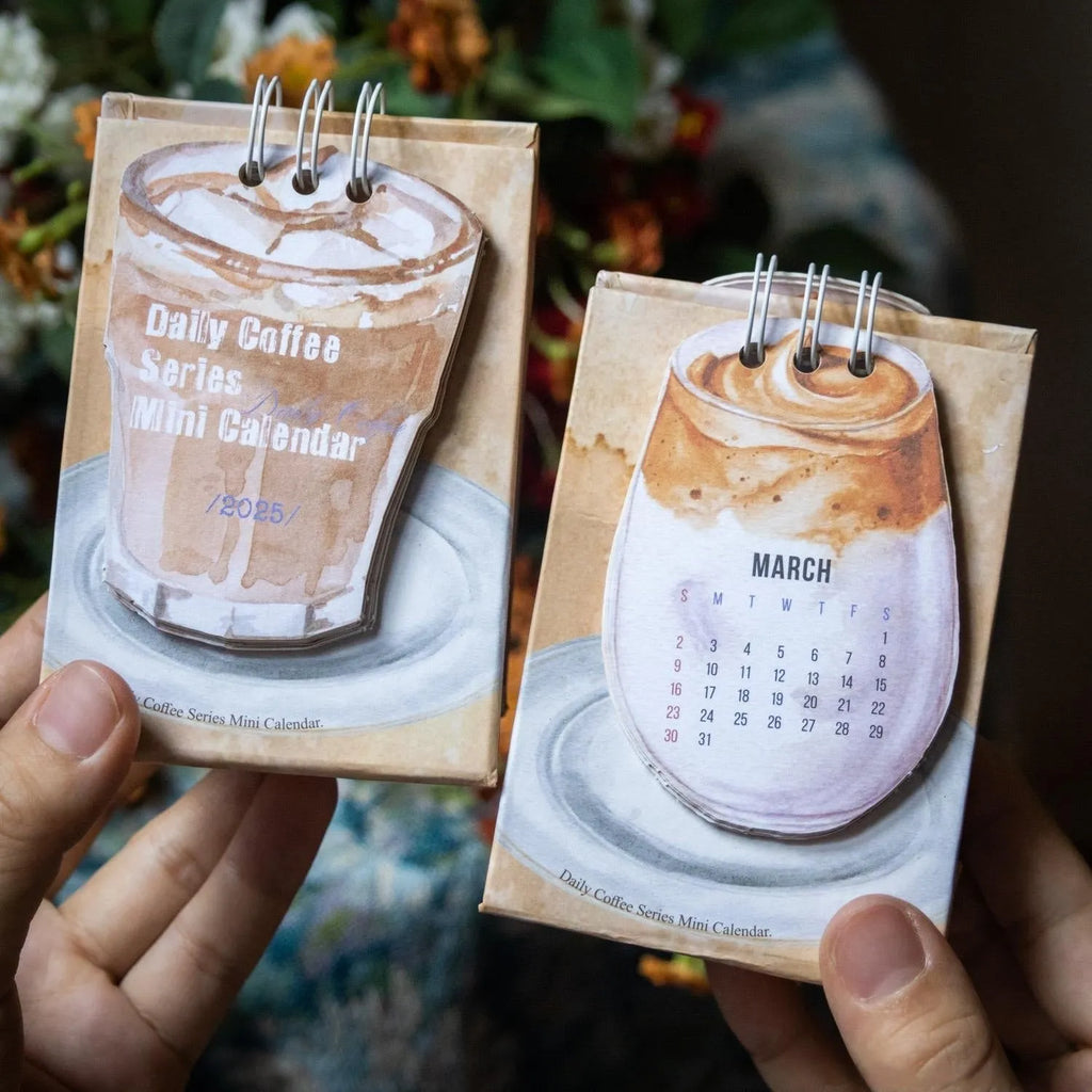 Mini 2025 desk calendar in a simple modern design on a wooden desk