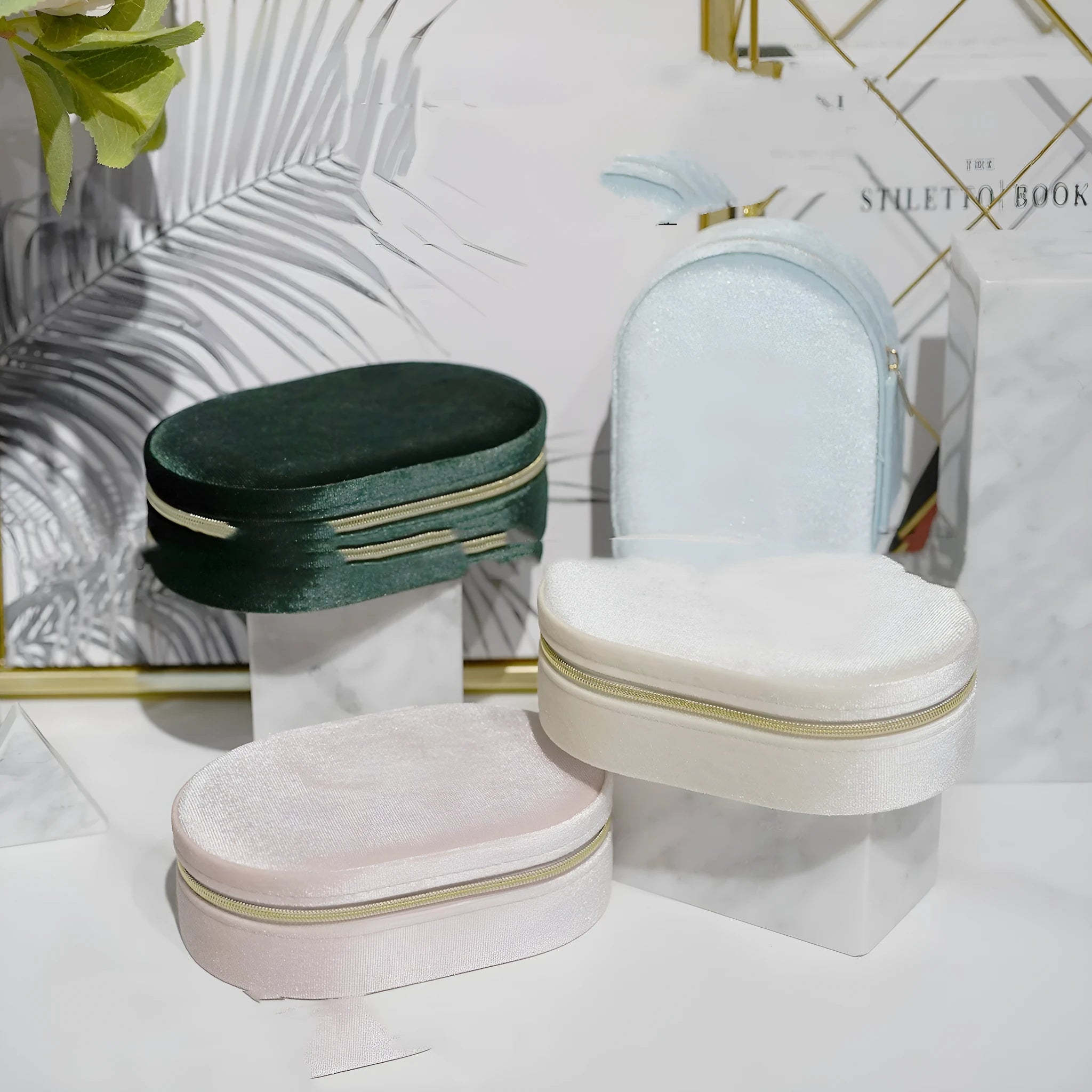 Oval velvet jewellery storage box in lake blue colour, showing flannel-lined interior and compact size.