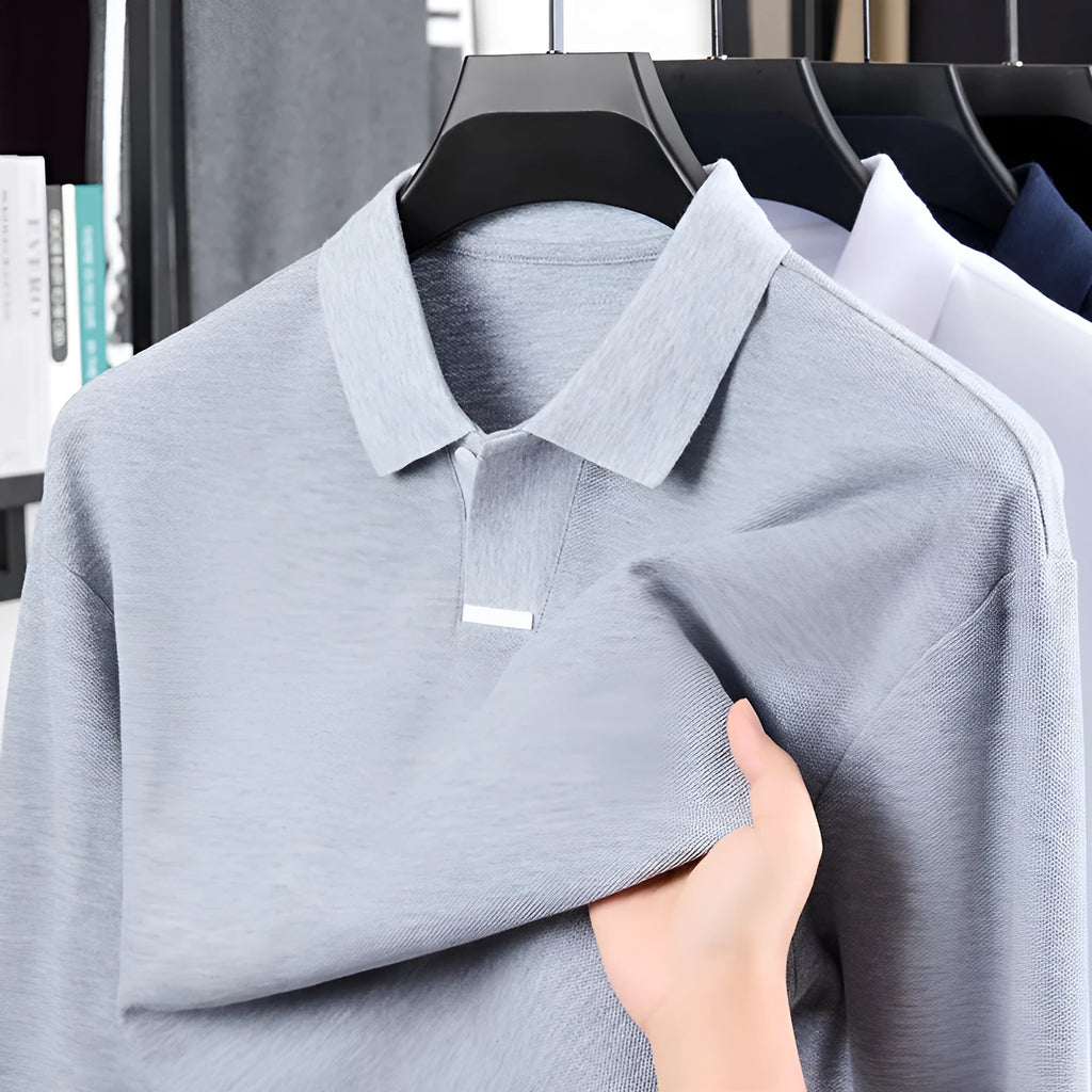 Men's grey loose fit cotton polo shirt with lapel collar and long sleeves on a hanger