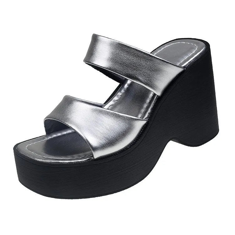 Women's black platform wedge slippers with a square toe design on a white background.