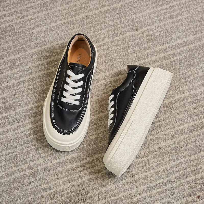 Women's black platform sports shoes with embossed cowhide upper and rubber sole, tied design detail
