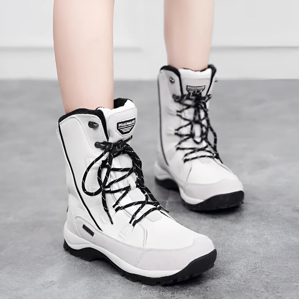 Women's black thermal snow boots with mid-calf height, round toe, and rubber sole.
