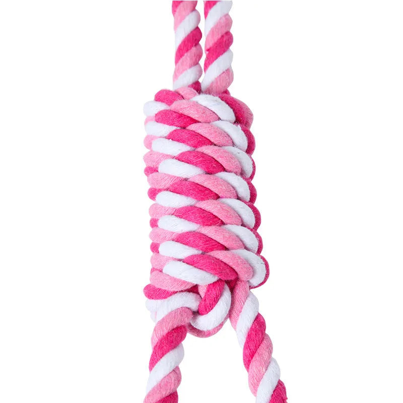 Red and white cotton string dog toy with ventilation holes, measuring approximately 38cm in length