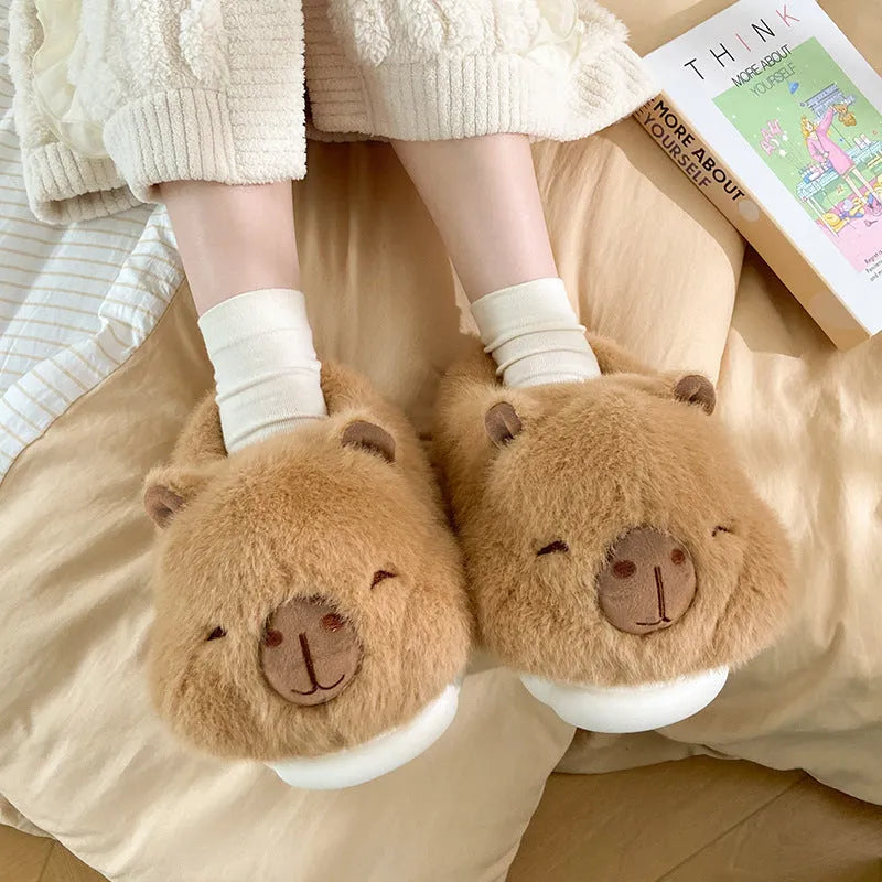 Light brown women's plush winter slippers with cartoon pattern and oversleeve design.