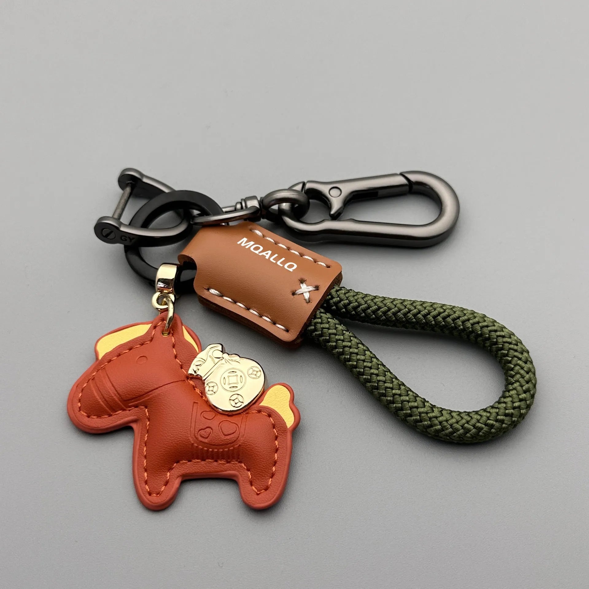 Handmade brown cowhide car key pendant with green flanelle rope and a metal buckle.