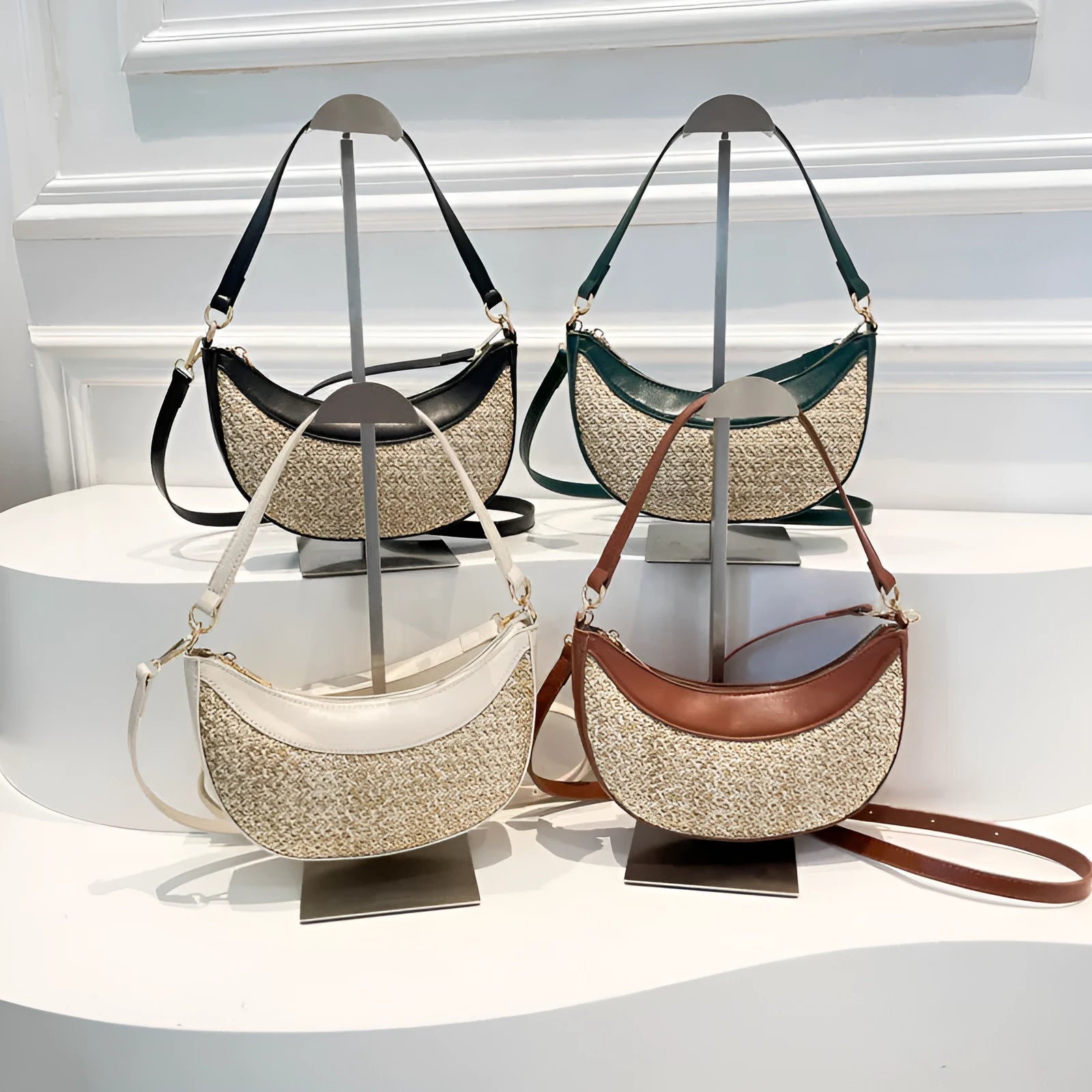 Hard woven straw dumpling-shaped crossbody bag in green with contrast stitching and a single shoulder strap.