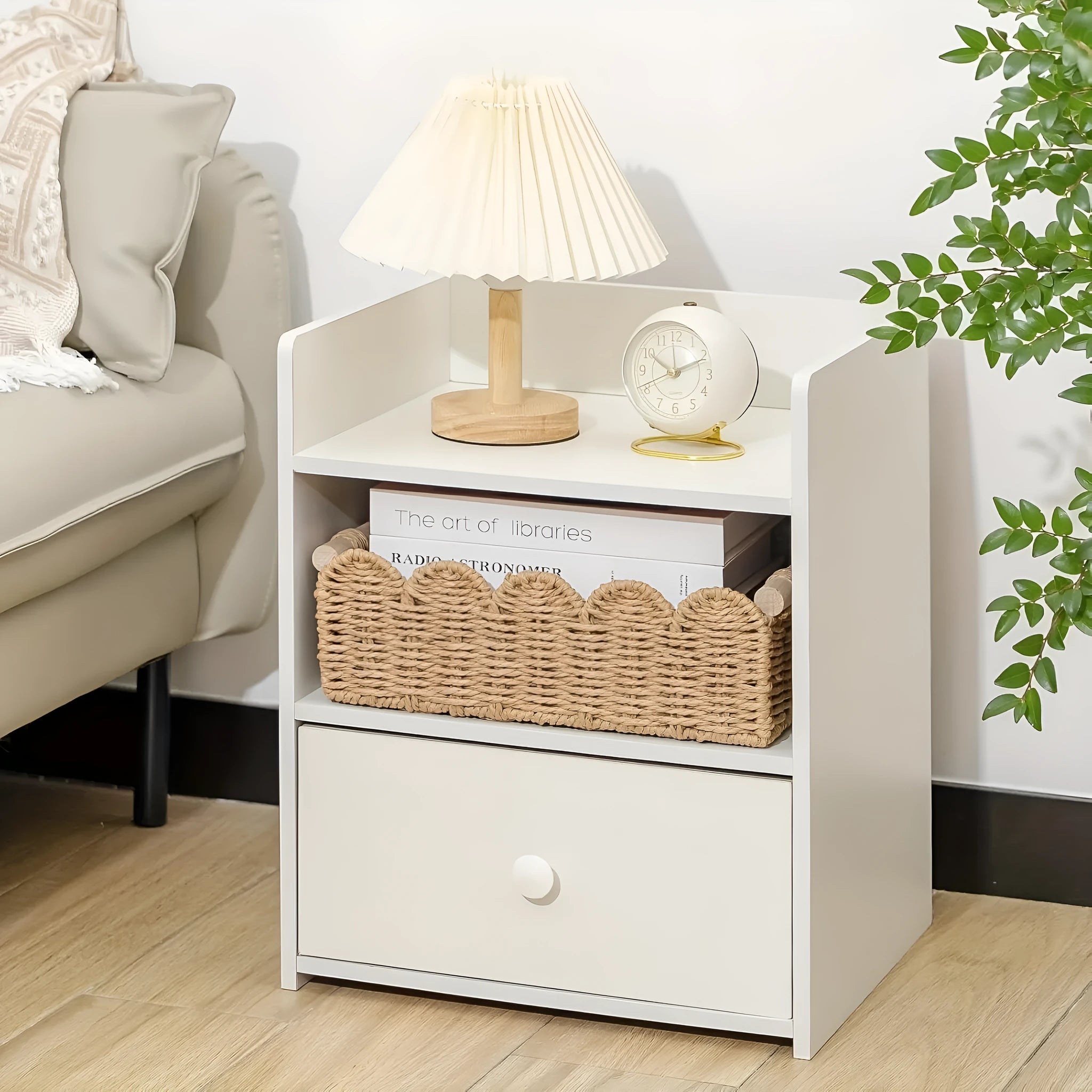 Woven paper storage basket in khaki colour on a desktop, holding remote controls and stationery.