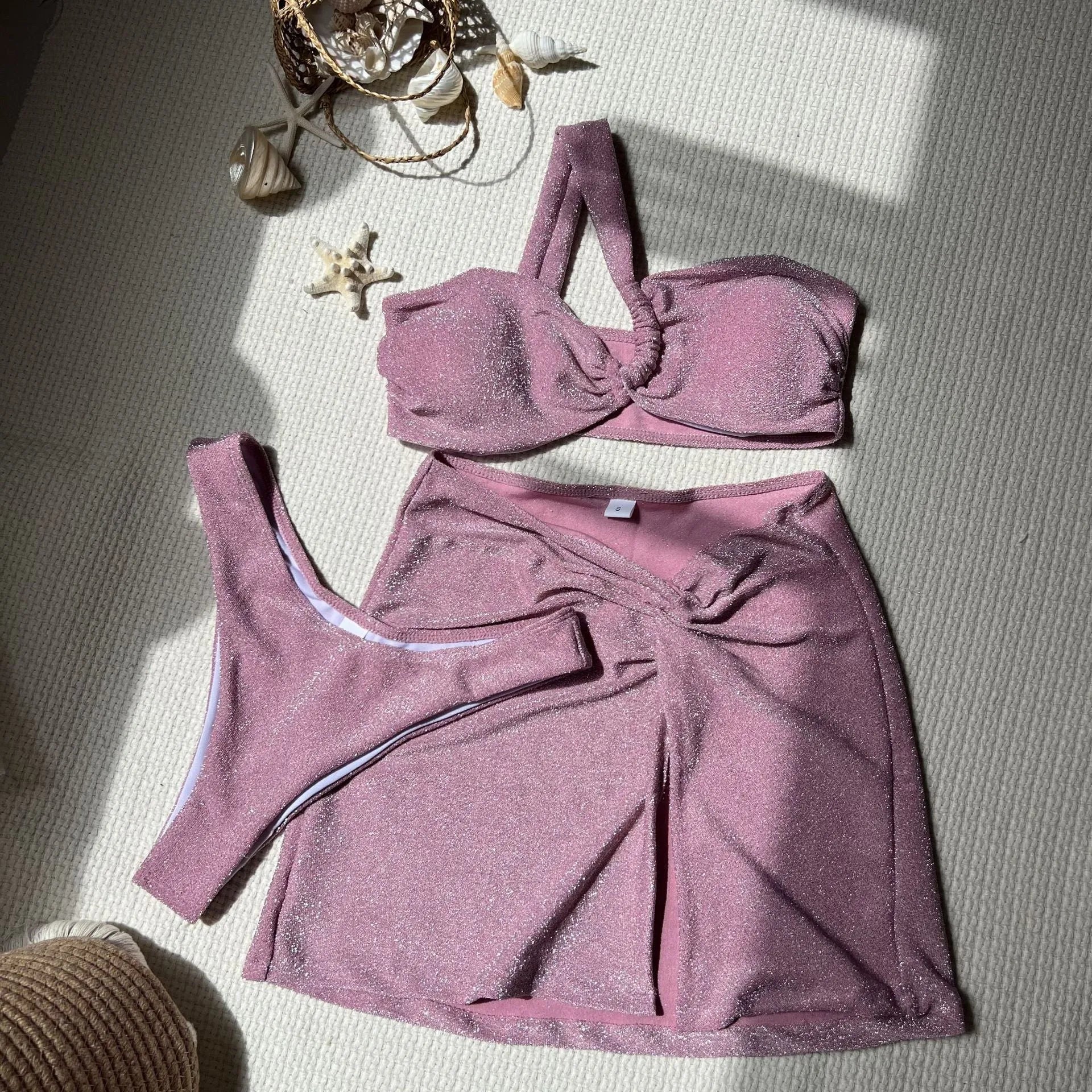Light green one-shoulder tube top swimsuit three-piece set with matching skirt on a mannequin.