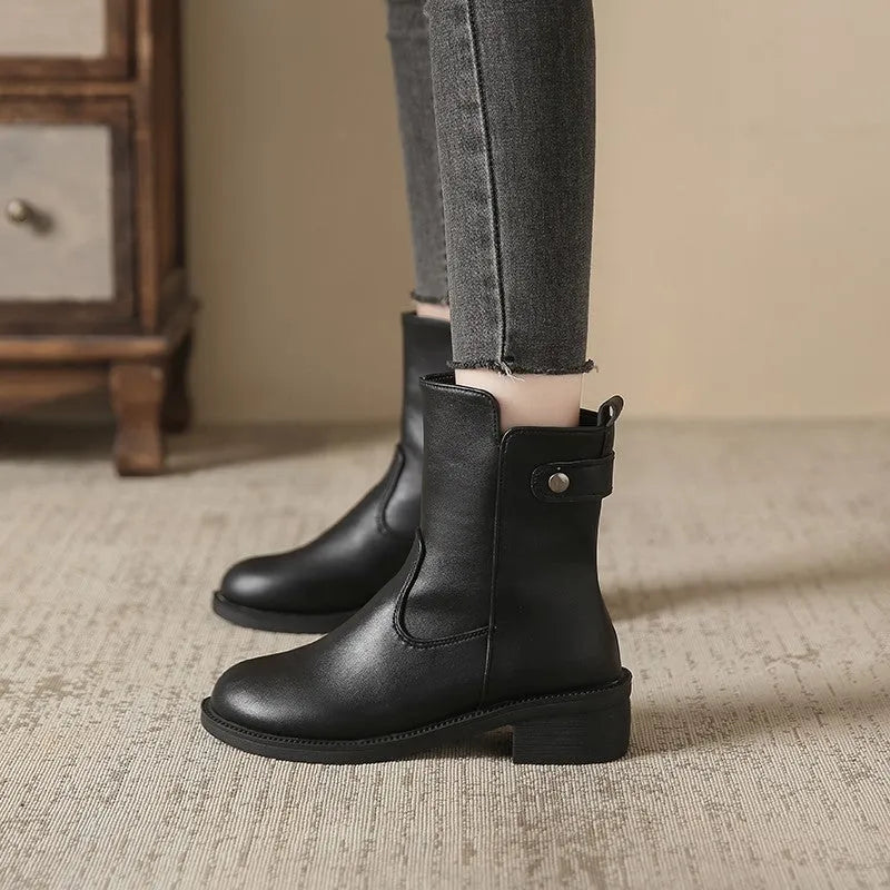 Black women's low heel ankle boots with a side zipper and round toe.