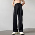 Black wide leg straight trousers with a loose casual fit on a hanger.