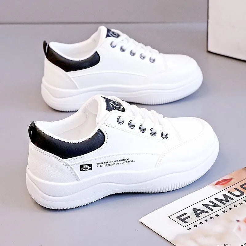 Women's white Korean-style leather pumps with cross straps and a flat mid-height heel.