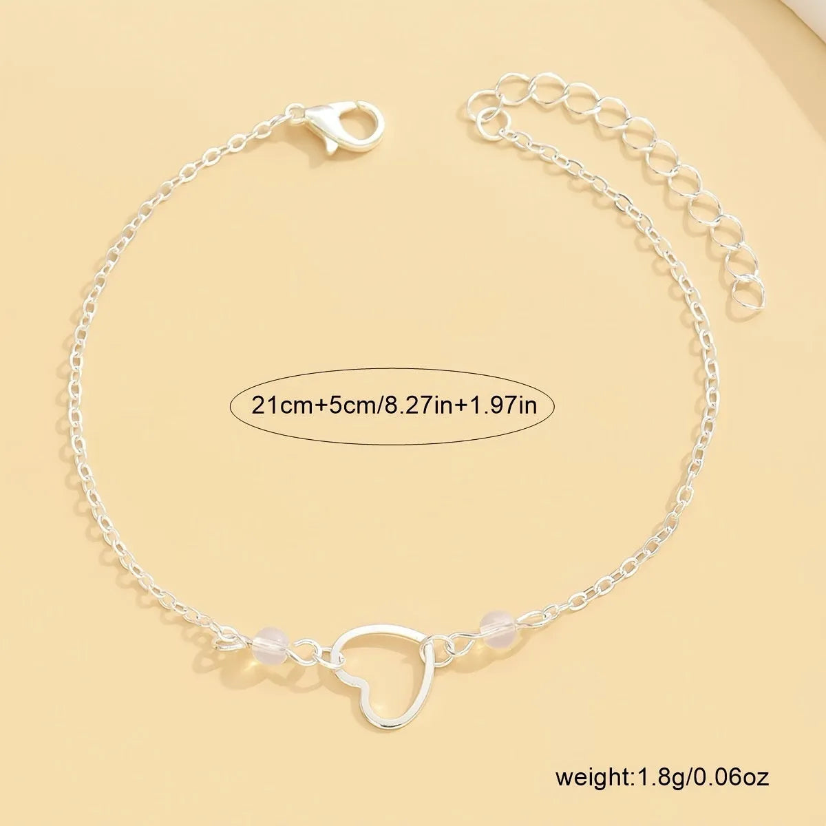 Adjustable women's anklet with heart-shaped pendant in gold or silver alloy metal