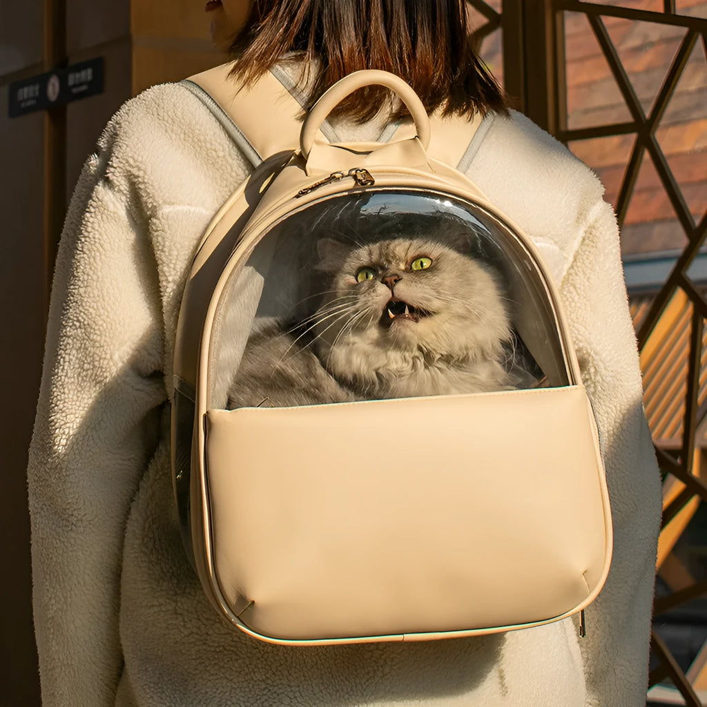 Fine grain leather transparent pet backpack carrier in beige with pet inside, front view