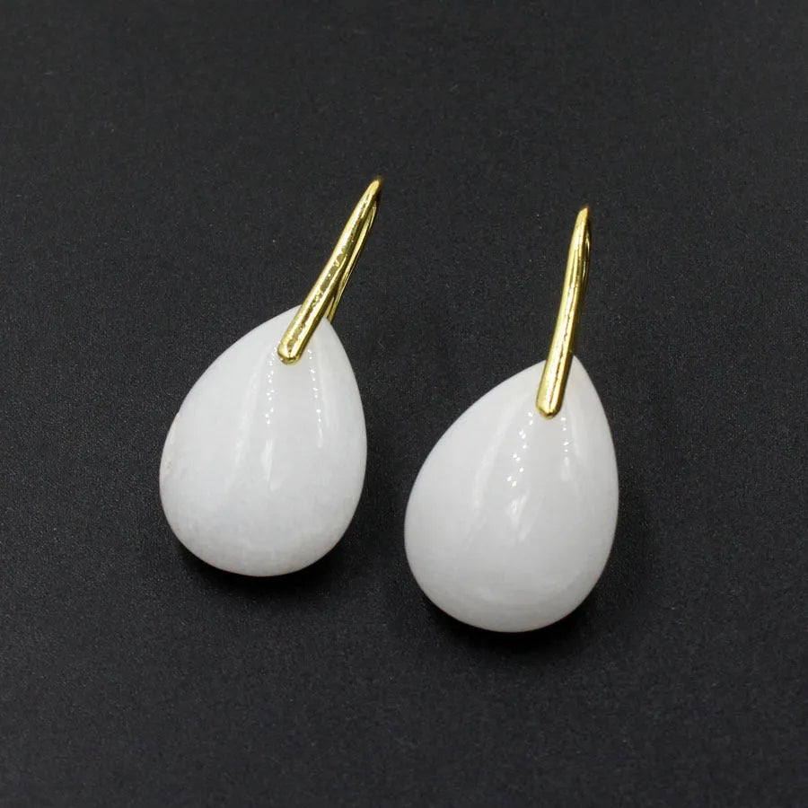A pair of geometric water drop earrings made from crystal in one of nine colours, with an electroplated metal setting.