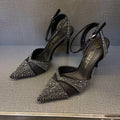 Women's black hollow high heels with red sole, stiletto heel and pointed toe design