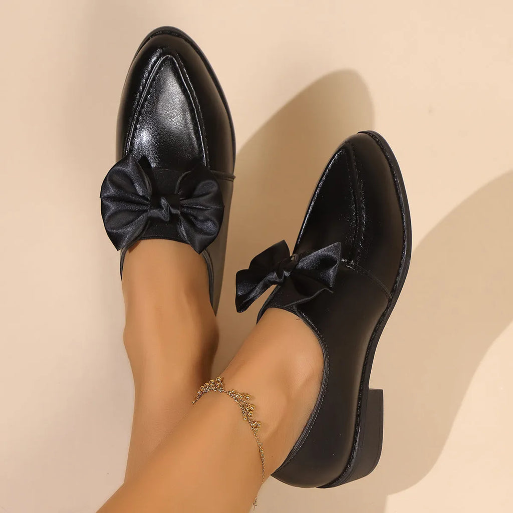 Women's British-style leather shoes with a decorative bow, rubber sole, and pointed toe.