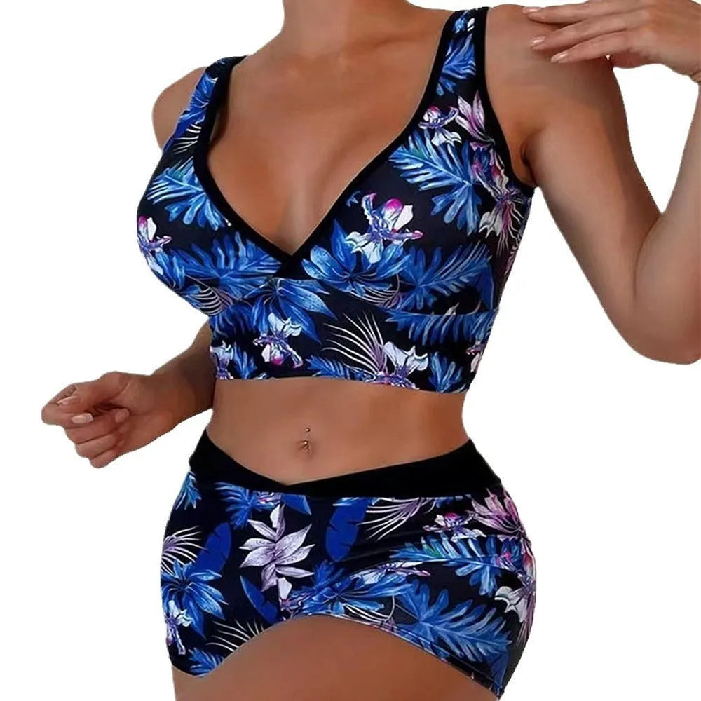Women's two-piece swimsuit set with sleeveless top and printed boxer-style bottoms in a multi-colour pattern.