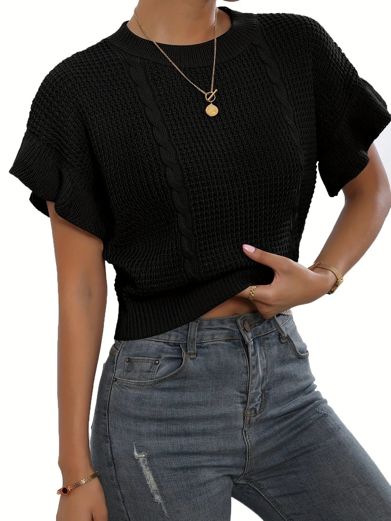 White knitted pullover sweater with 3D twisted string pattern and ruffled short sleeves on a hanger.