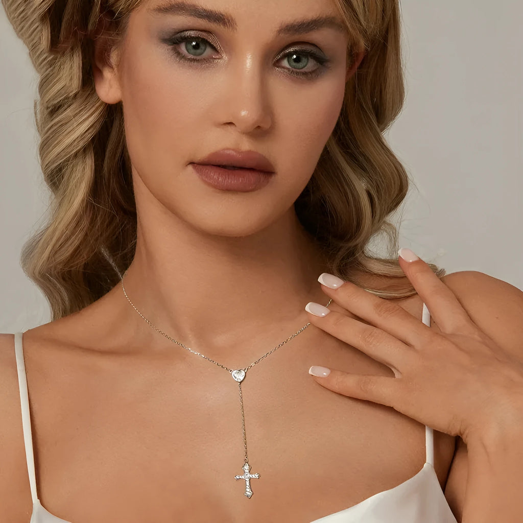 Simple sterling silver V-neck cross pendant on an O-ring chain necklace.