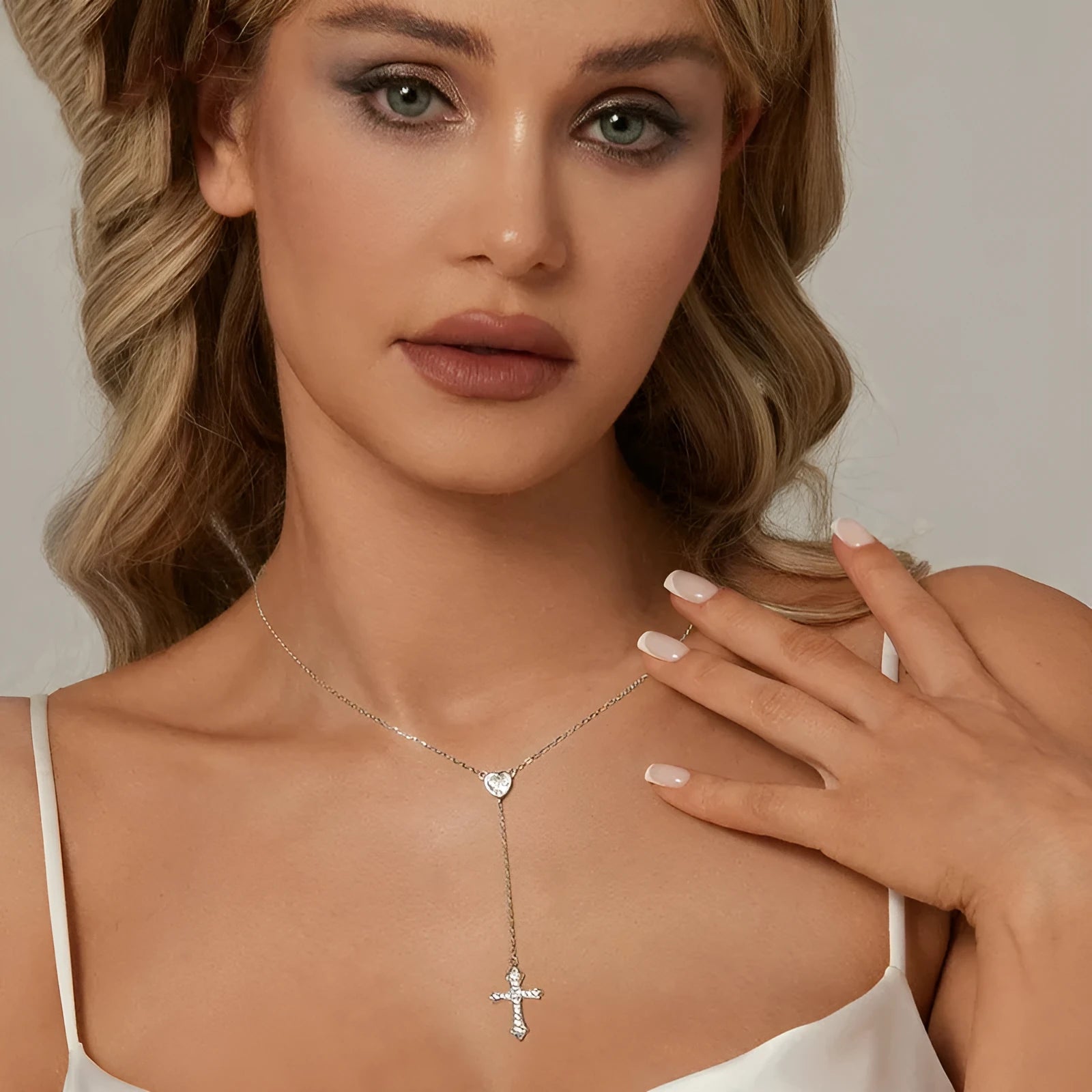 Simple sterling silver V-neck cross pendant on an O-ring chain necklace.
