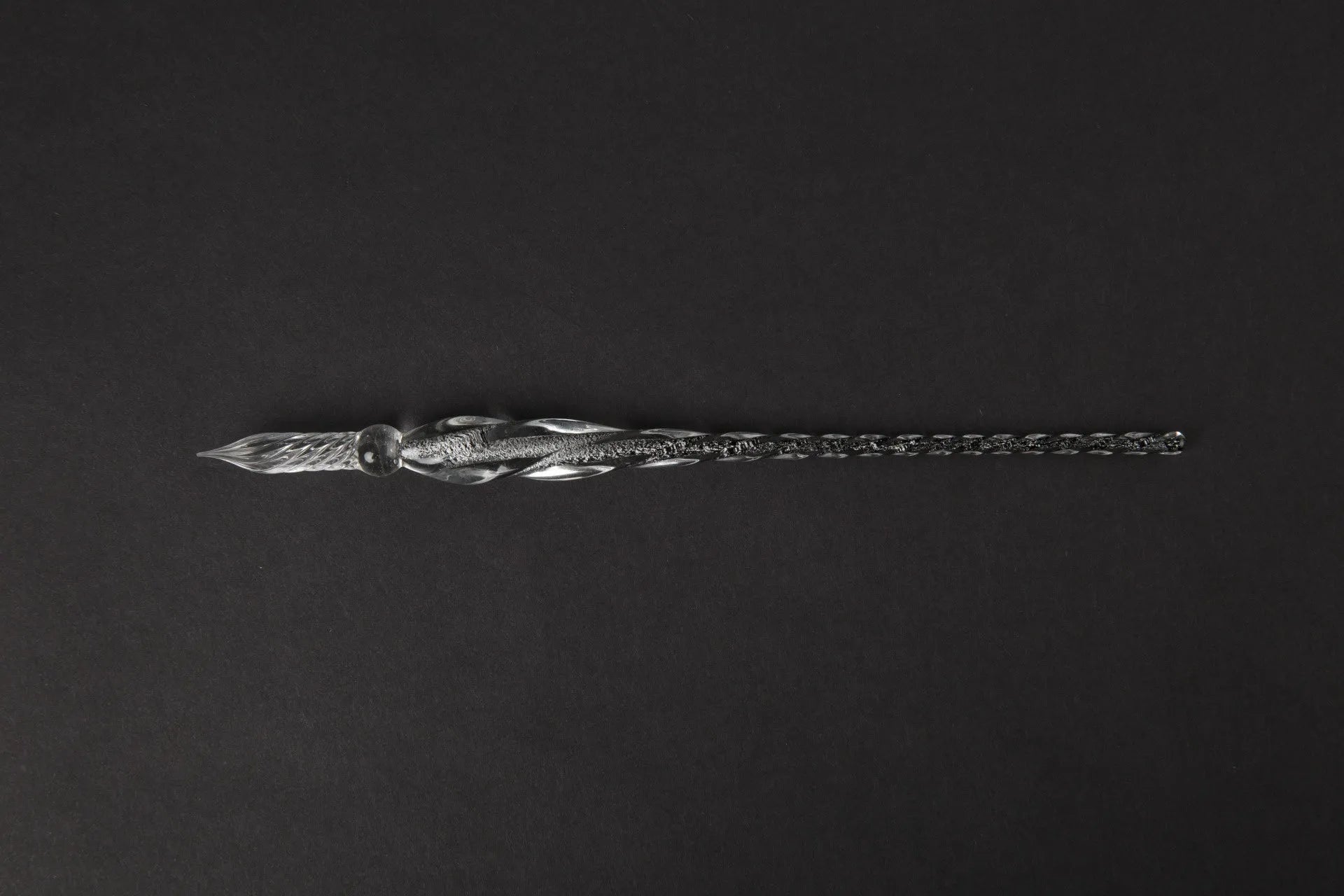 Transparent glass signature pen with coloured ink visible inside, abstract modelling, gift box packaging