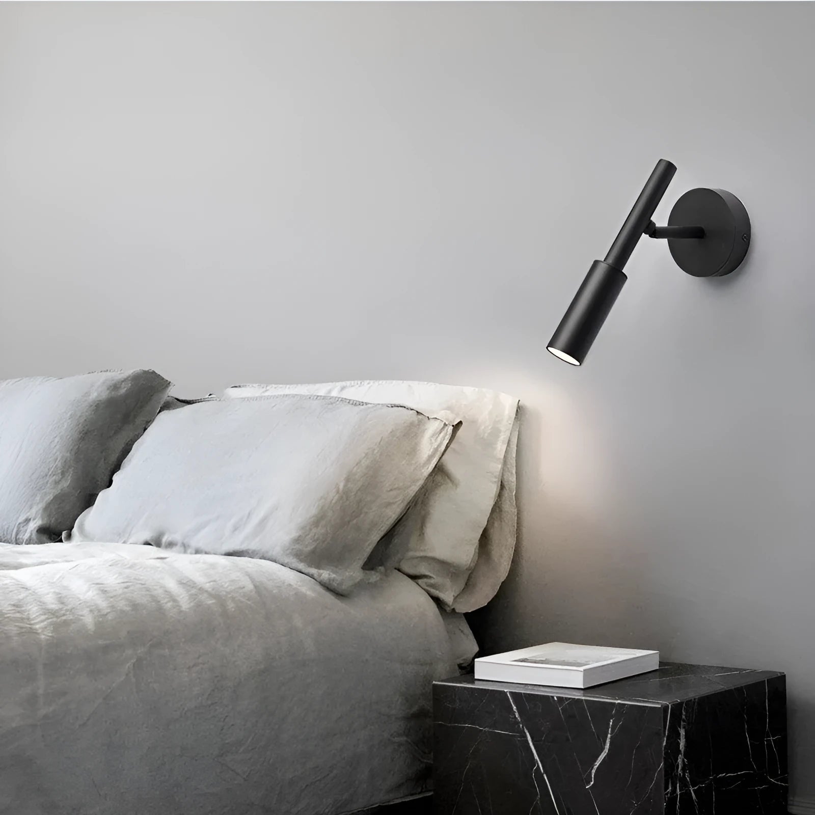 Modern wrought iron wall lamp in black or white, 100mm by 230mm, with three colour light options.