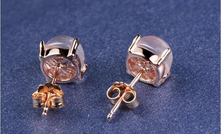 Women's rose gold drop-shaped stud earrings with synthetic Ross quartz and crystal inlay detail