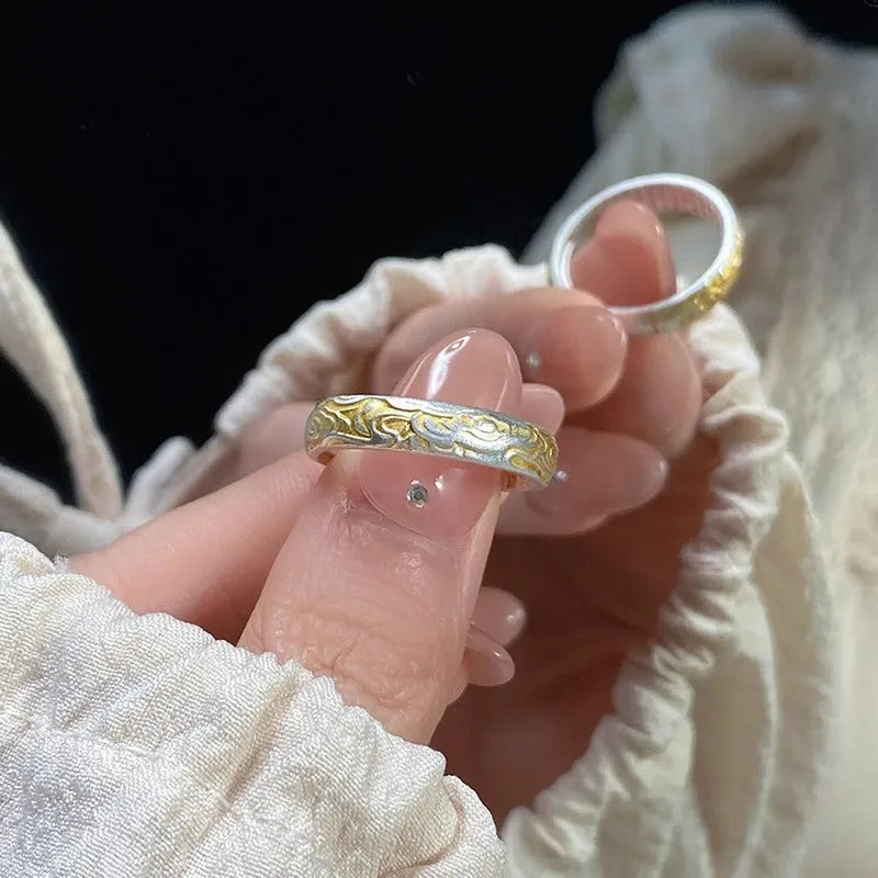 Geometric xiangyun pattern open mouth ring in silver electroplated finish on white copper.