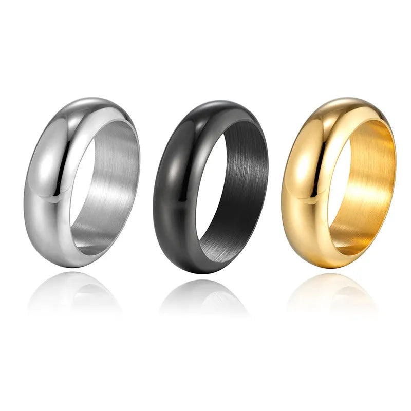 Glossy electroplated titanium steel ring shown in gold, black, and steel colour finishes on a grey background.