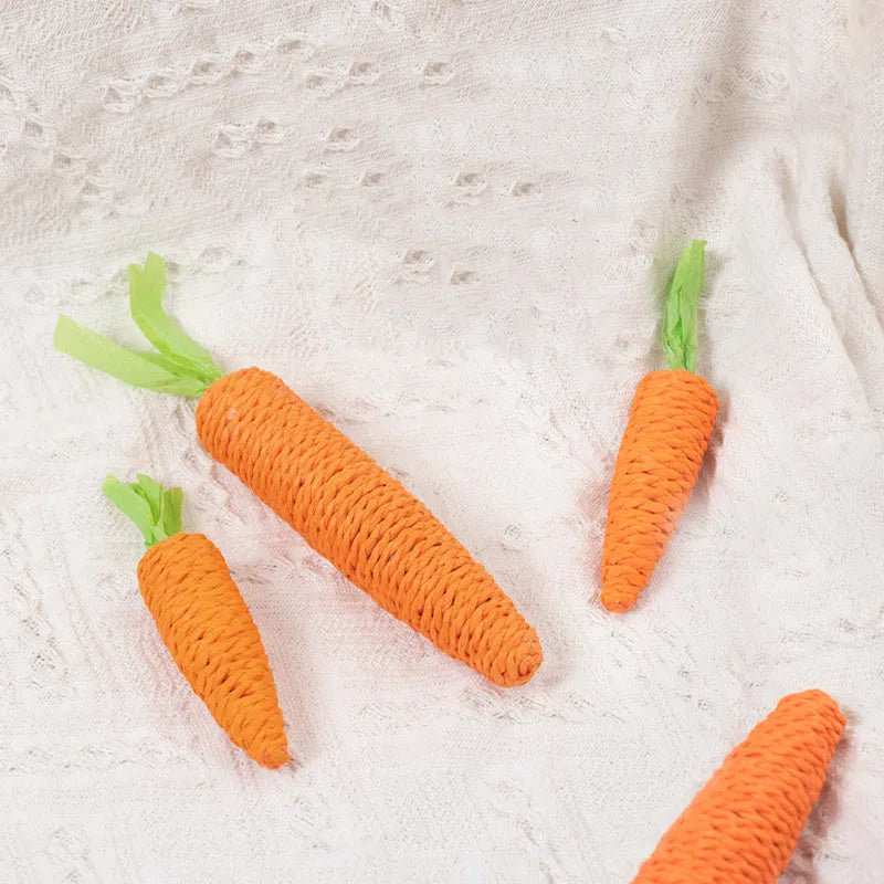 Assortment of cat toys including carrot-shaped paper bites, plastic ringing stones, and textured grinding sticks in two size options