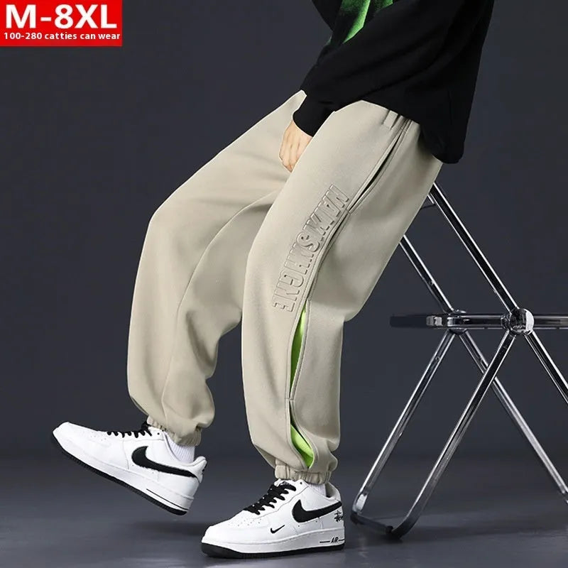Men's loose fit cotton trousers with banded ankles and stitching details in grey green colour