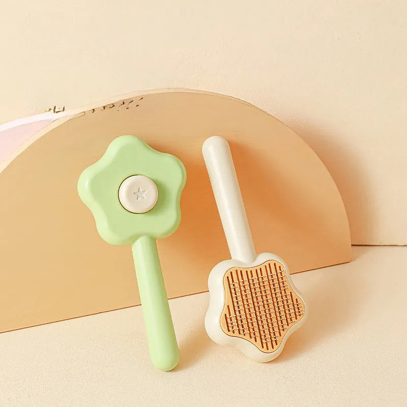 Green self-cleaning stainless steel pet comb with a magic wand handle on a white background.