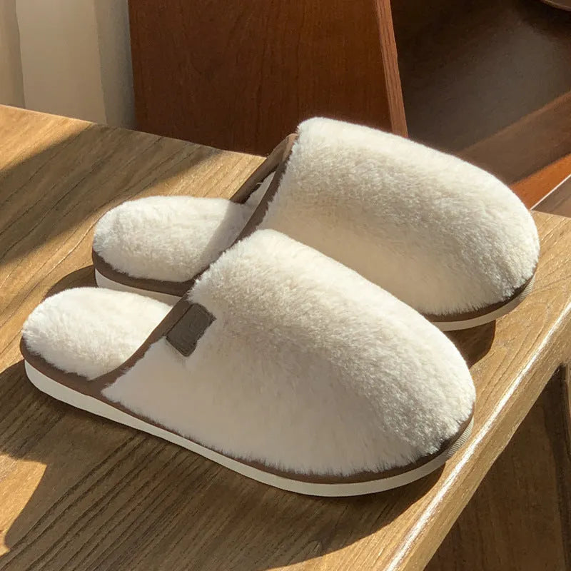 Solid colour PVC winter plush house slippers with car stitching detail on a non-slip sole.