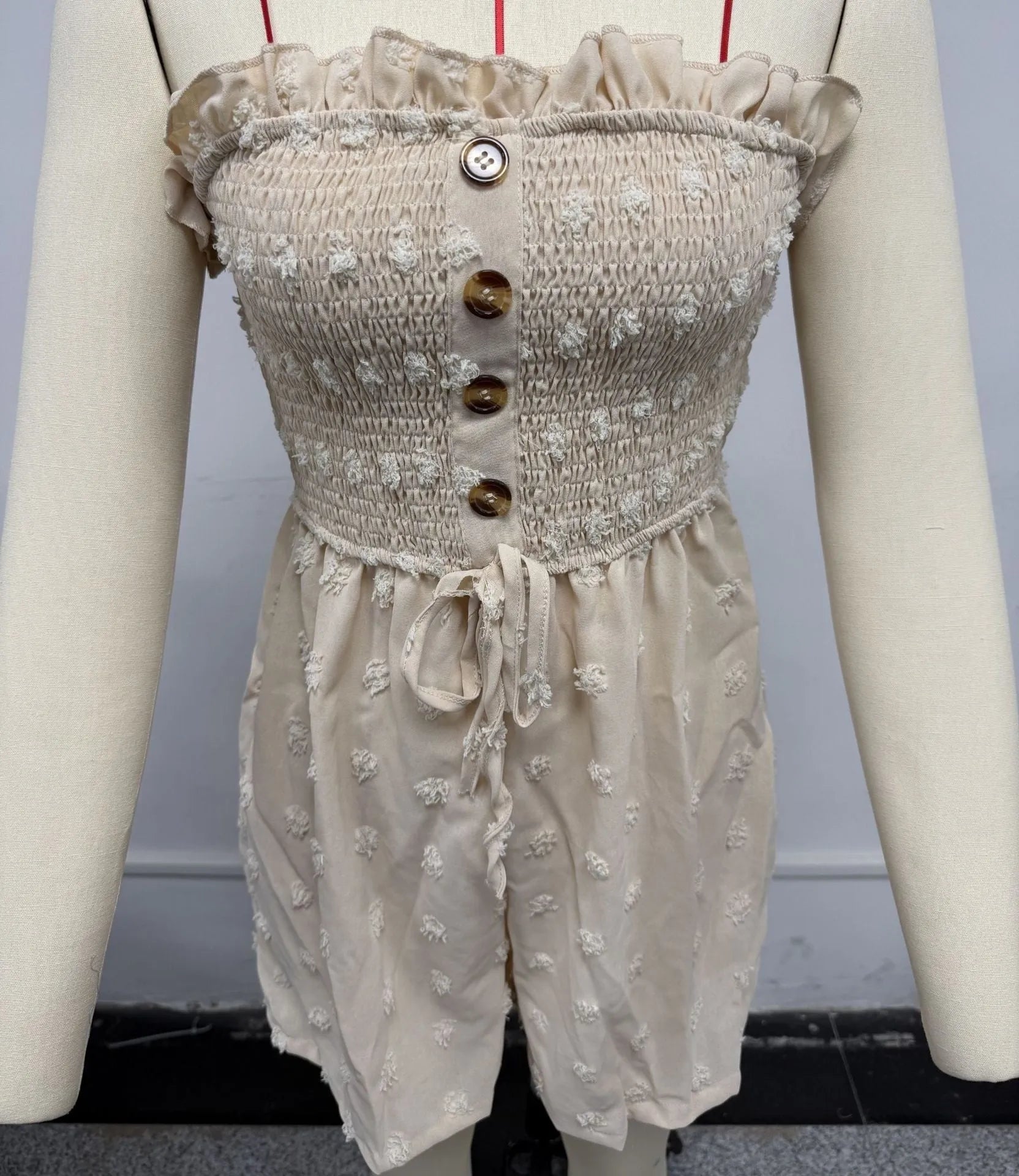Women's sleeveless off-shoulder jumpsuit in solid colour with elastic waist and button details