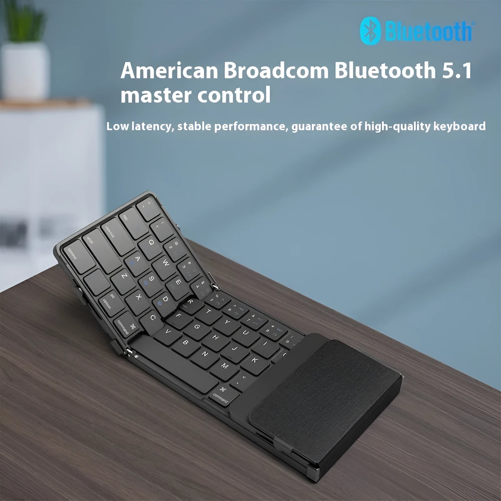 Black folding Bluetooth keyboard for mobile phones and tablets shown unfolded.