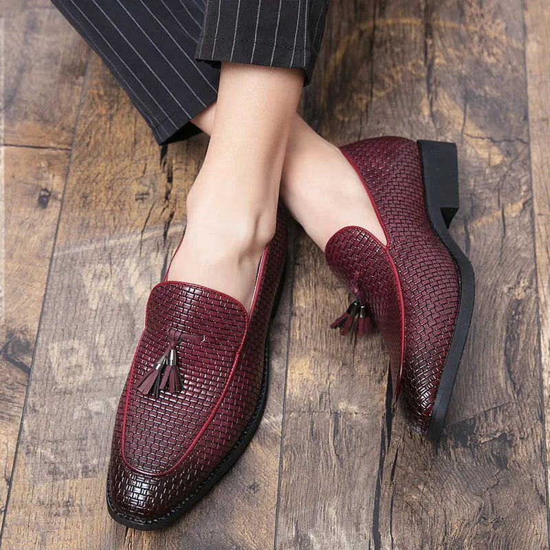 Men's black pointed slip-on business shoes with tassel detail on artificial PU leather upper