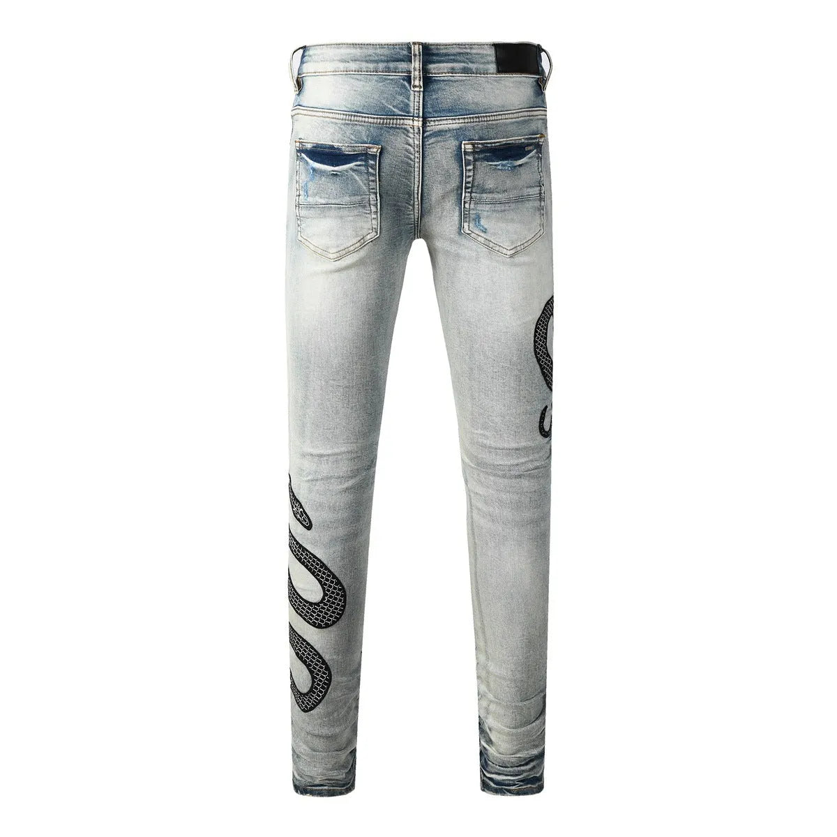 Man's blue distressed skinny jeans with a vintage wash, shown on a model, featuring a button fly and a tapered leg.