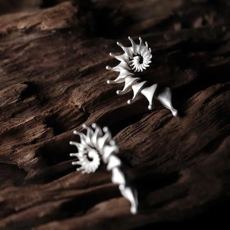 A pair of conch-shaped stud earrings with a three-dimensional matte finish in an irregular simple style.