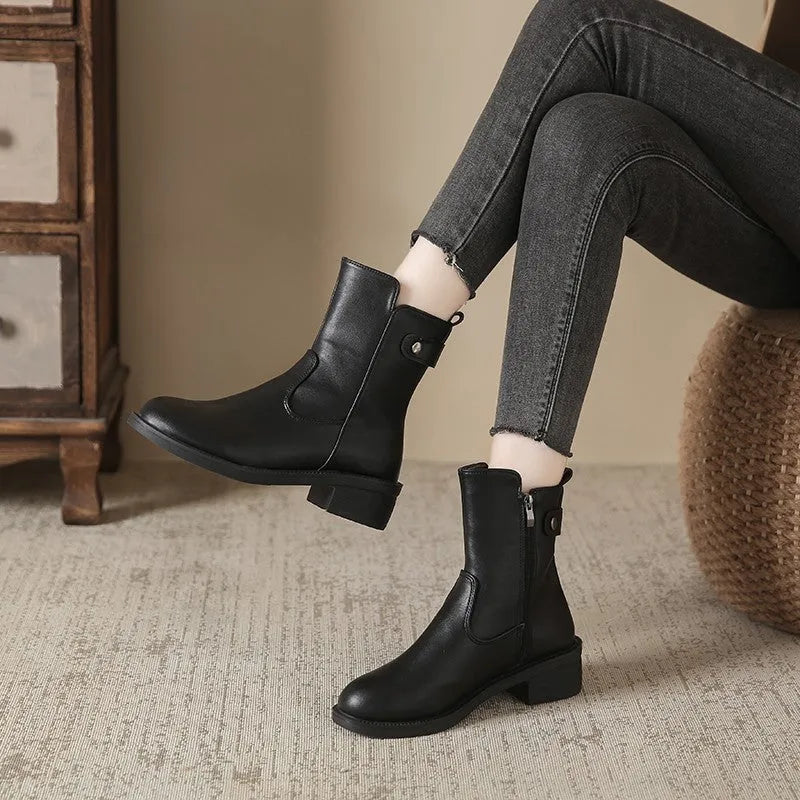 Black women's low heel ankle boots with a side zipper and round toe.